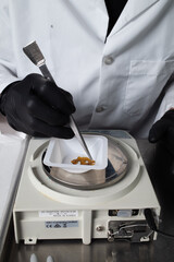 Gloved Worker Weighing & Packaging Cannabis Extract