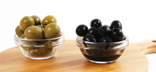 Black and green olives in glass containers. Christmas table. Shallow depth of field	