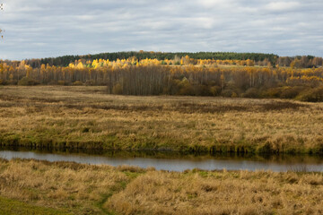 Autumn contryside landscape. Fields and small river