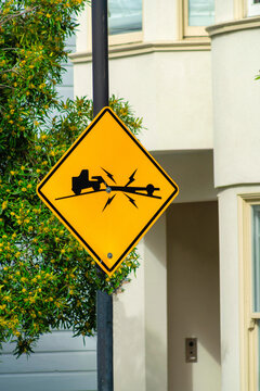 Yellow Road Sign With Black Paint In The City That Depicts A Warning For Trailers Given A The Steep Slopping Hills