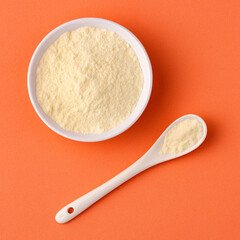 Powdered milk with nutrients in the bowl and spoon