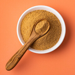Maca powder in the bowl and spoon - Lepidium meyenii.