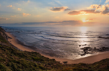 Evening summer ocean view over Carriagem beach at low tide (Aljezur, Algarve, Portugal).