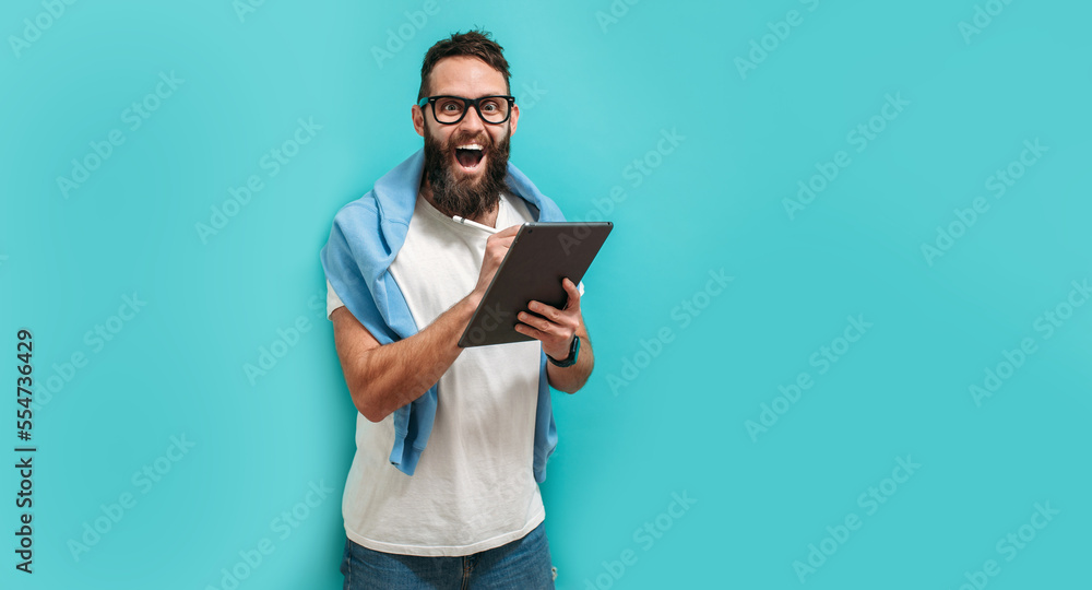 Poster professional designer working on digital tablet computer using stylus pen isolated over blue color b