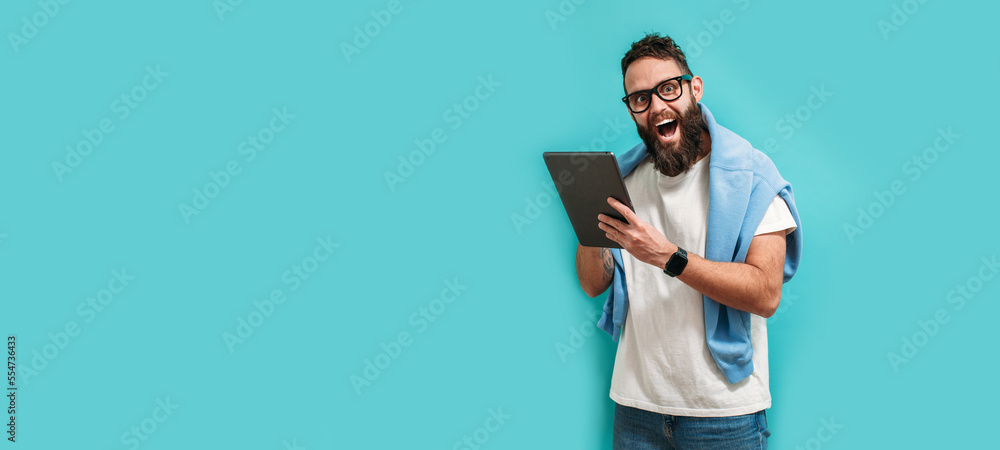 Poster professional designer working on digital tablet computer using stylus pen isolated over blue color b