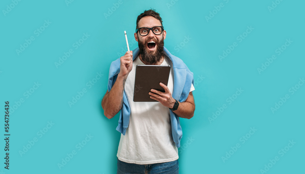 Poster professional designer working on digital tablet computer using stylus pen isolated over blue color b