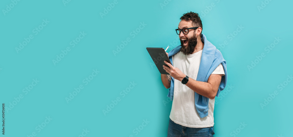 Poster professional designer working on digital tablet computer using stylus pen isolated over blue color b