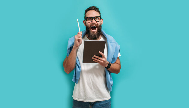 Professional designer working on digital tablet computer using stylus pen isolated over blue color background.