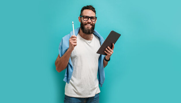 Professional designer working on digital tablet computer using stylus pen isolated over blue color background.