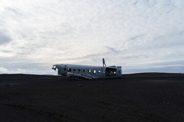 black beach with a plane wreck iceland