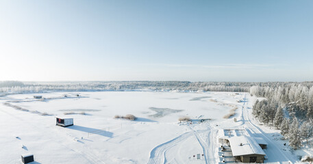 Fototapeta premium Forest in snow. Aerial view of a winter woods Snowy tree branch in a view of the winter forest