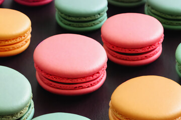 Fototapeta na wymiar a lot of macaron with different color on black floor background