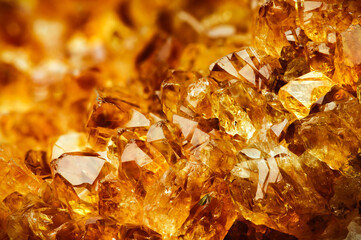 Citrine yellow quartz macro detail texture background. close-up raw rough unpolished semi-precious gemstone
