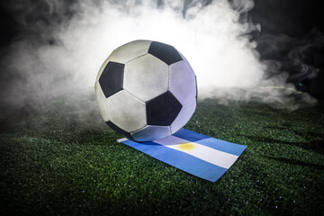 Soccer 2022. Grand Final Argentina vs France theme. Soccer ball on green grass. Support your country or cheer concept.