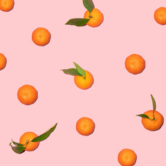 Tangerine pattern on pastel light pink background. Minimalistic fruit concept. Creative summer nature composition.
