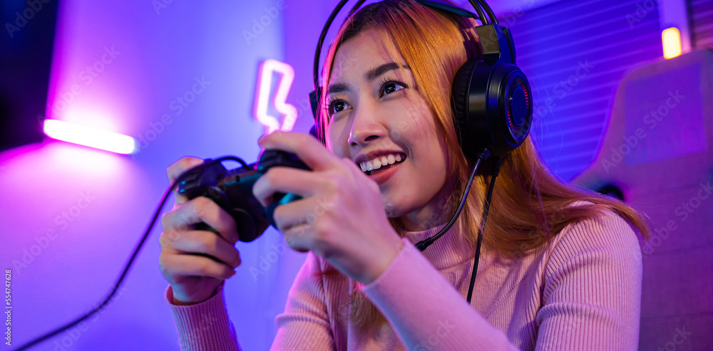 Aufkleber you win. gamer using joystick controller plays online video game with computer neon lights she winni