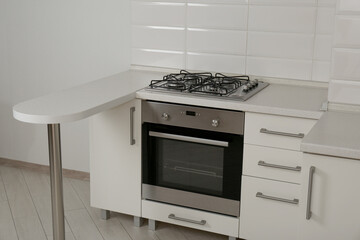 Fototapeta premium New gas stove and oven in stylish kitchen