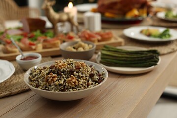 Festive dinner with traditional Christmas kutia served on table indoors. Slavic dish
