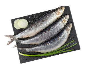 Slate plate with salted herrings, spices and onion isolated on white, top view