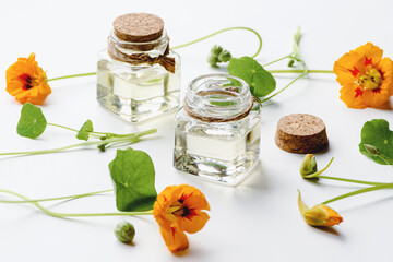 Nasturtium Oil, Tropaeolum majus flowers leaves seeds on white background