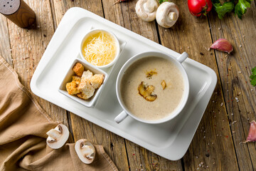 Cream soup of mushrooms on wooden table top view