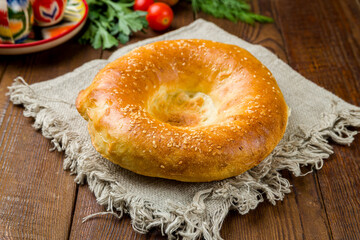 Uzbek bread from tandoor on old wooden table