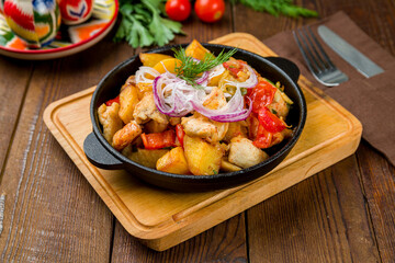 Fried Chicken, potatoes and vegetables on old wooden table
