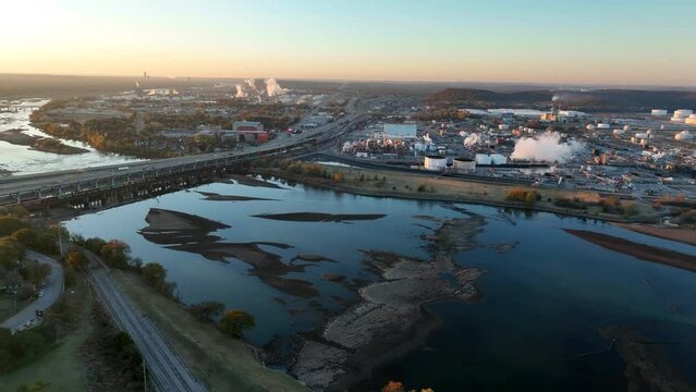 Arkansas River in Tulsa Oklahoma with oil and gas fuel refinery. Aerial at sunrise.