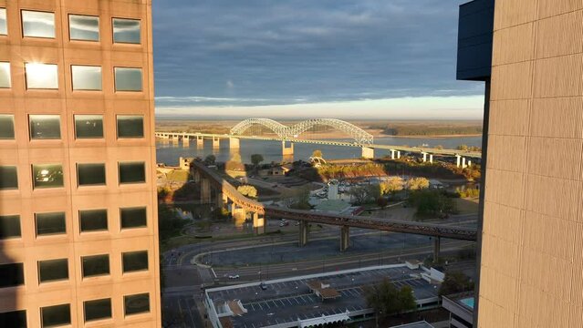 Downtown Memphis aerial reveal of Mississippi river Interstate 55, Hernando de Soto bridge at golden hour. Aerial view.