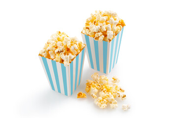 Two blue white striped carton buckets with tasty cheese popcorn, isolated on white background. Movies, cinema and entertainment concept.