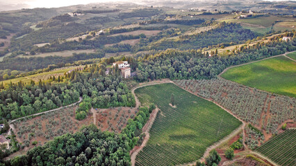 A vineyard with a large home on the property, as seen from a hot air balloon over Tuscany, Italy.