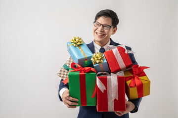 Portrait of confident Asian businessman in glasses carrying gift box isolated on white background