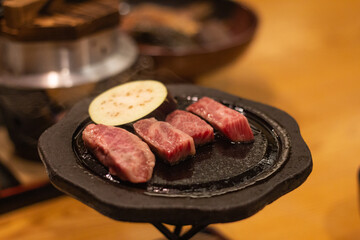 Wagyu beef and eggplant on a pan, cooking food. Aso, Kumamoto, Japan