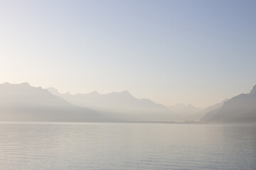 Panoramic view of Lake Leman or Lake of Geneva with morning mist over the water surface. Copy space
