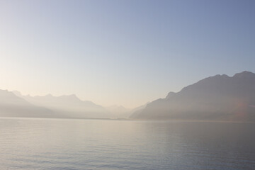 Panoramic view of Lake Leman or Lake of Geneva with morning mist over the water surface. Copy space