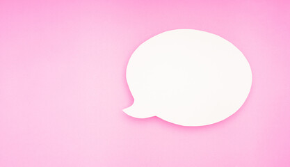 A blank white speech bubble on a pink background