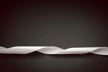 White ribbon isolated on a black background