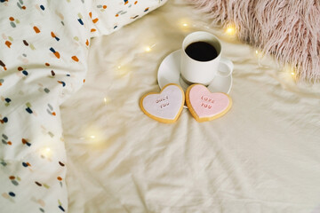 A cup of coffee with delicious cookies with the inscription love you. Celebrating Valentine's Day at home. Concept of Valentine's Day