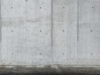 Gray concrete wall and asphalt flooring