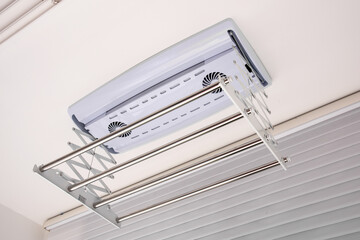 Clothes drying rack installed on the ceiling