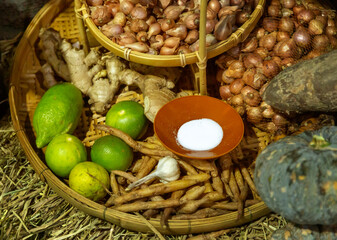 Thai herb ingredient with onion, lime, ginger, garlic, and salt on rattan basket