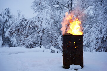 Fire barrel burning garbage during the winter.