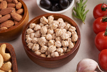 Healthy food. Vegetables, lemon and chickpeas on concrete background, Vegetarian food or Mediterranean cuisine concept, copy space. Fruit, vegetables, grain, nuts olive oil on wooden table.