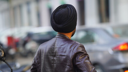 Young Punjabi man watching parking for car