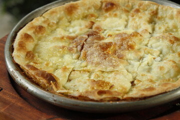 Closeup of thin crust flatbread stuffed with cheese