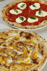 Margherita pizza with tomato sauce, buffalo cheese and basil and carbonara pizza with bacon, cheese and egg yolks
