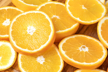 Juicy oranges on a background of ice cubes with copy space on a blue background