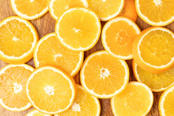 Juicy oranges on a background of ice cubes with copy space on a blue background