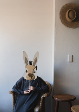 girl holding a rabbit mask in the room