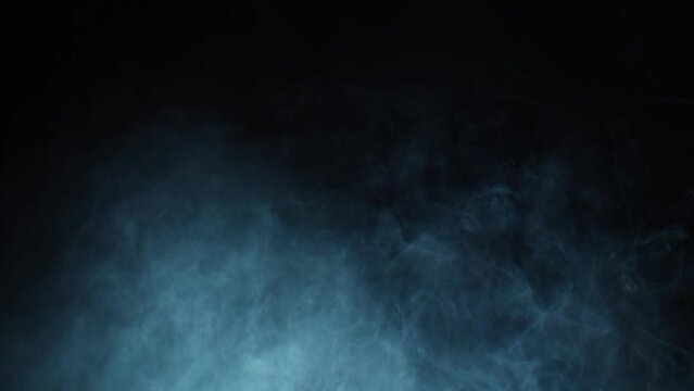Cinematic layered VFX atmosphere. HD slow-motion VFX smoke appears from the side on a black lingers, disturbed by a subtle wind. Featuring hanging smoke and practical non-sourced smoke.